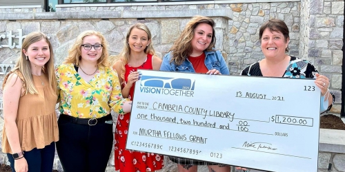 A photo of students holding a large check